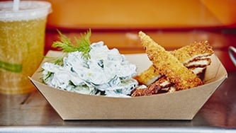 Schnitzels de poulet et salade de concombre allemande de Schnitzel Truck